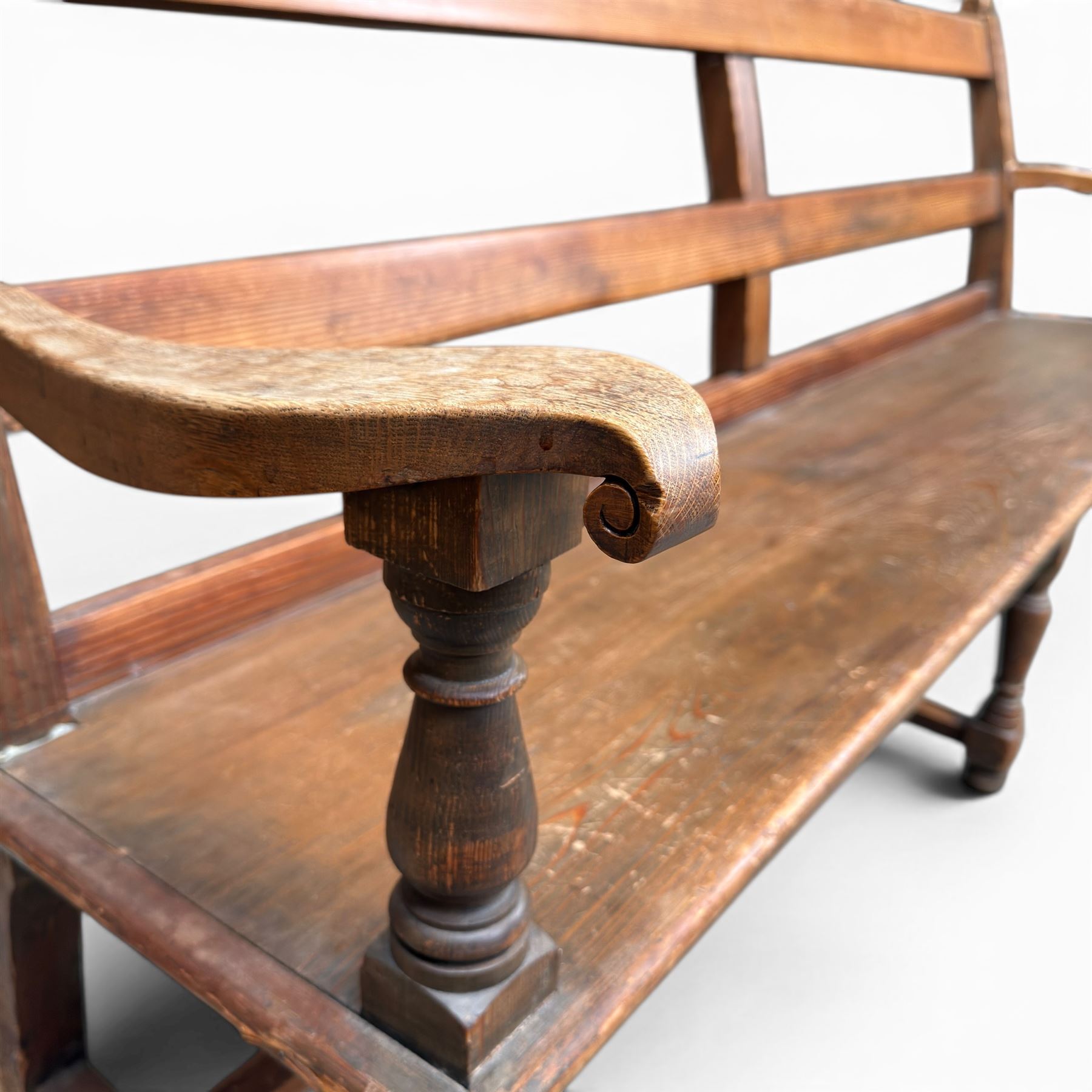 Early 20th century pine and oak bench seat, stained pine rail back frame with shaped oak arms