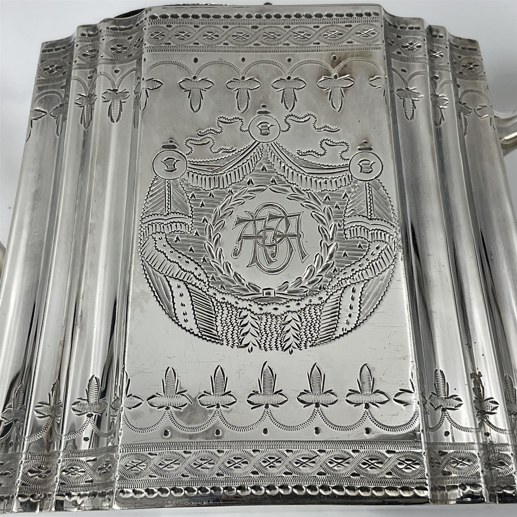 Victorian three-piece silver tea service, comprising teapot, twin handled open sucrier and milk jug, of oval form with shaped rim and C handles, each engraved with crests and bands of strapwork decoration, the milk jug and sucrier with gilt interiors, hallmarked Josiah Williams & Co, Exeter 1881, the teapot with ivory insulators and finial, all contained with a tooled leather, blue silk and velvet lined fitted case, retailed by West & Sun, Dublin 
This item has been registered for sale under Section 10 of the APHA Ivory Act