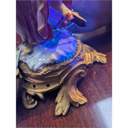 Mid 18th century Meissen figure group, The Tyrolean Dancers, circa 1740, modelled as two swirling figures with their arms linked, he in yellow hat with red rosette, blue jacket, red breeches with red rosette, and yellow shoes with green rosette, she in white blouse with red ribbons, yellow and red bodice, white apron over puce skirt and yellow shoes with green rosettes, her hair fashioned into two plaits secured by red ribbon, upon a shaped mound base, within a scrolling gilt metal mount, with blue crossed swords mark to base, overall H19cm
