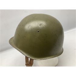 Two 1960s East Block Soviet style helmets - Czechoslovakian and Russian; both with liners (2)