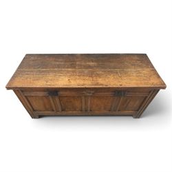 Large 17th century oak coffer, plank top with moulded edge, four panel front with channel moulded uprights, retaining original wrought iron strap hinges and central lock plate, panelled ends, raised on stile supports