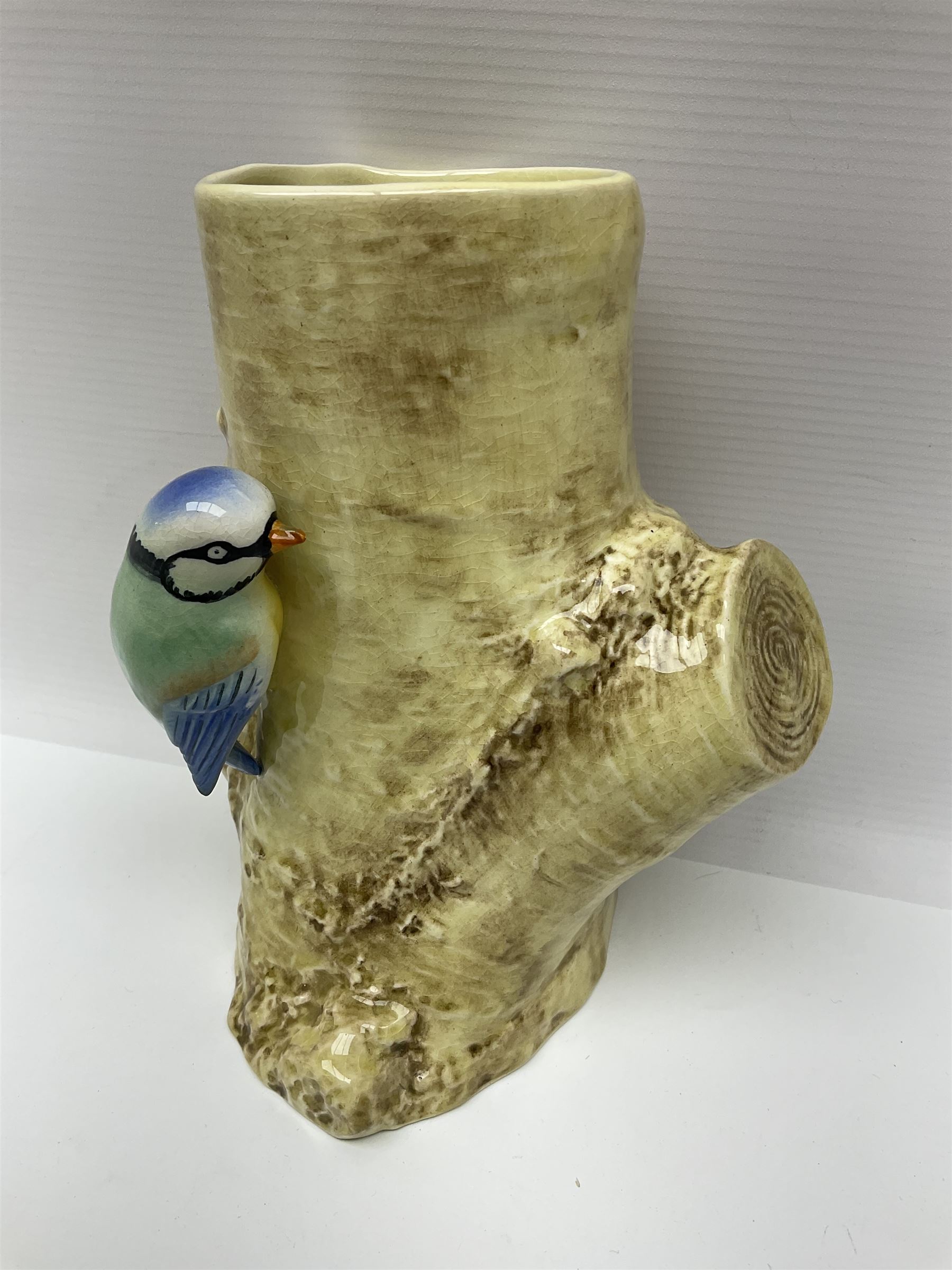 Sylvac budgieregar wall pocket, together with other Sylvac cermics including swan vases, blue tit vase and a frog figure etc, all with printed or impressed marks beneath, and a Poole Pottery cat figure, with printed mark beneath, wall pocket H22cm