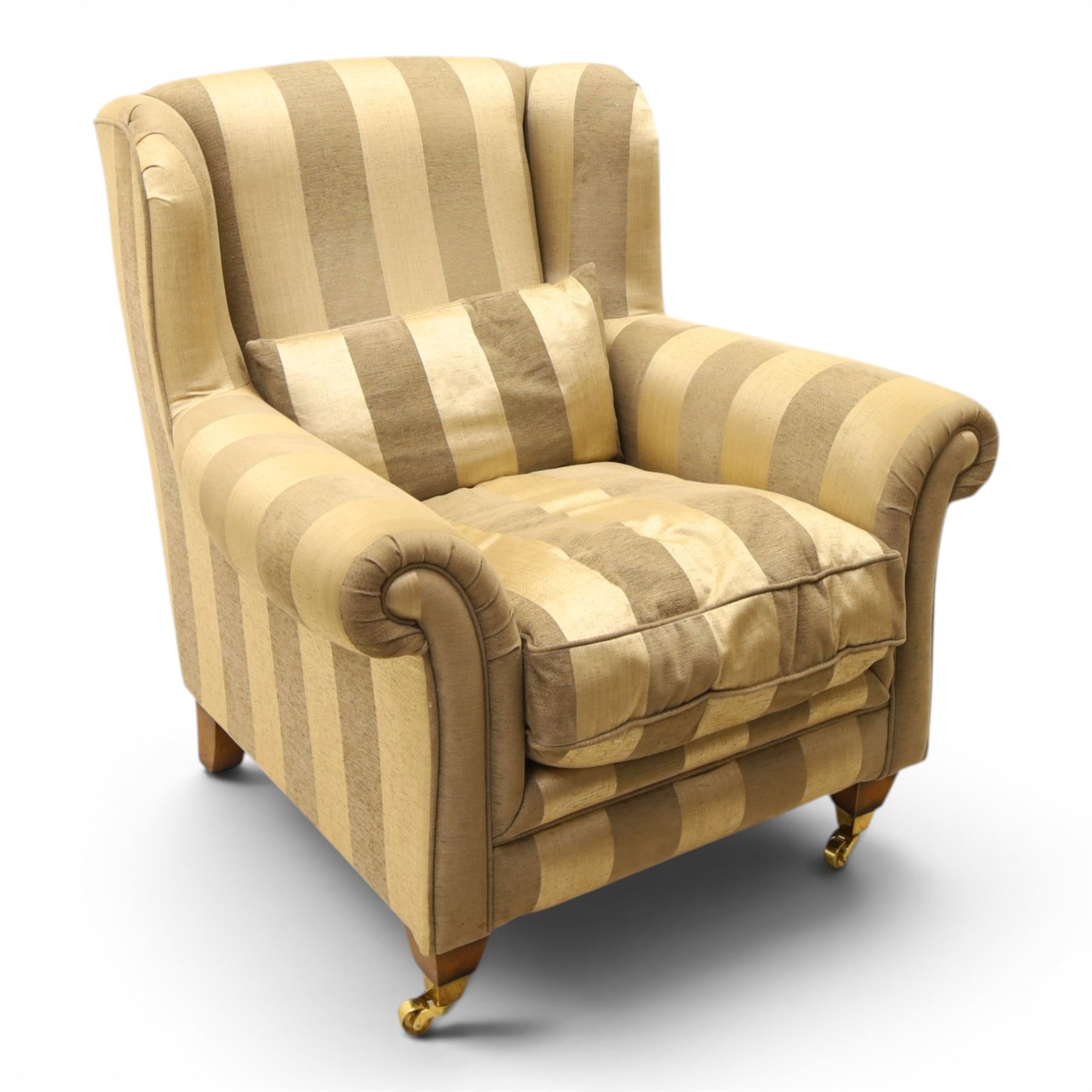 Alstons - 'Ixworth' armchair, upholstered in striped fabric, with loose seat cushions and scrolled arms, brass front castors