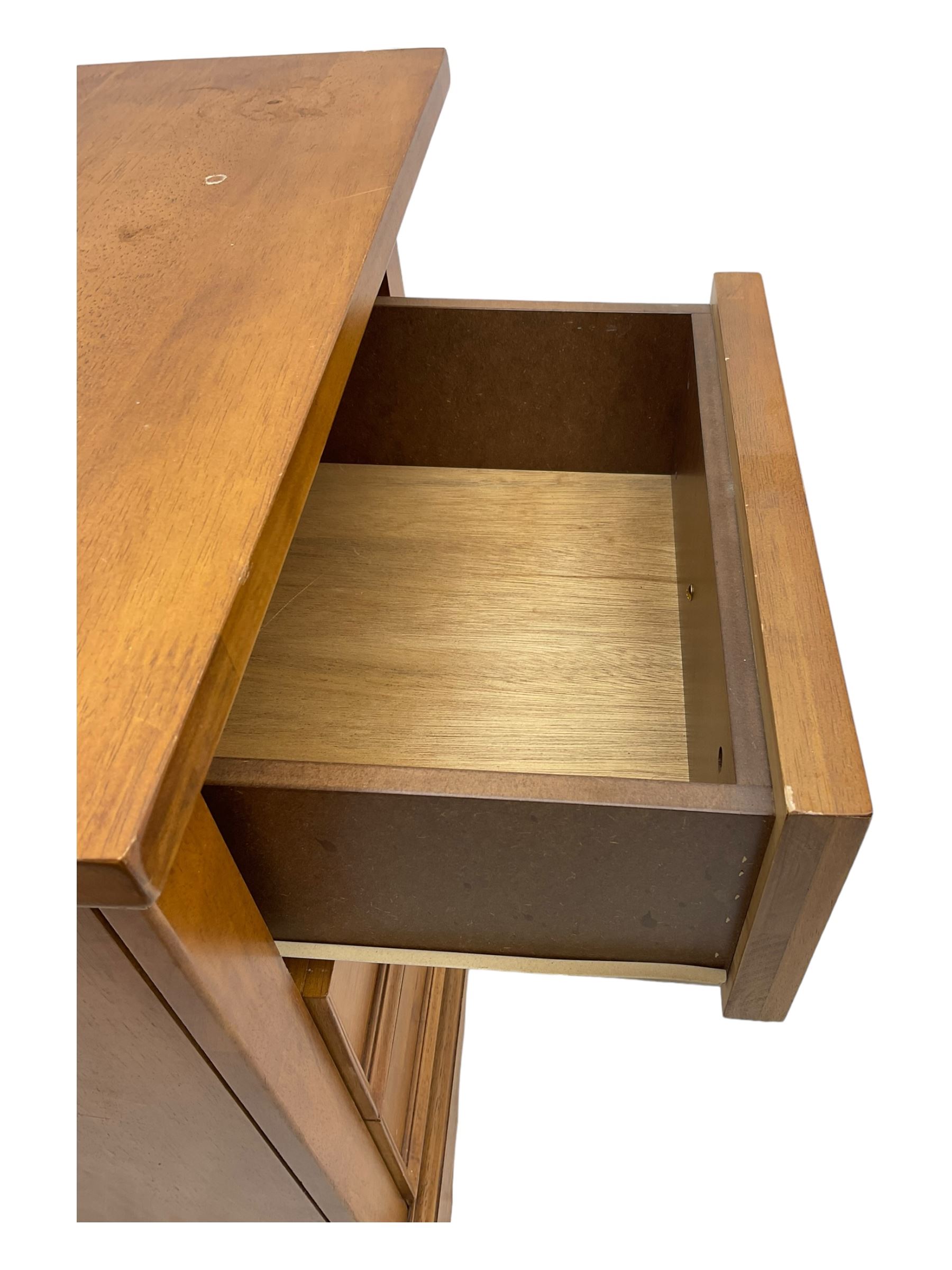 Pair of contemporary cherry wood bedside chests, rectangular top and projecting moulded cornice over three drawers, on plinth base with shaped apron