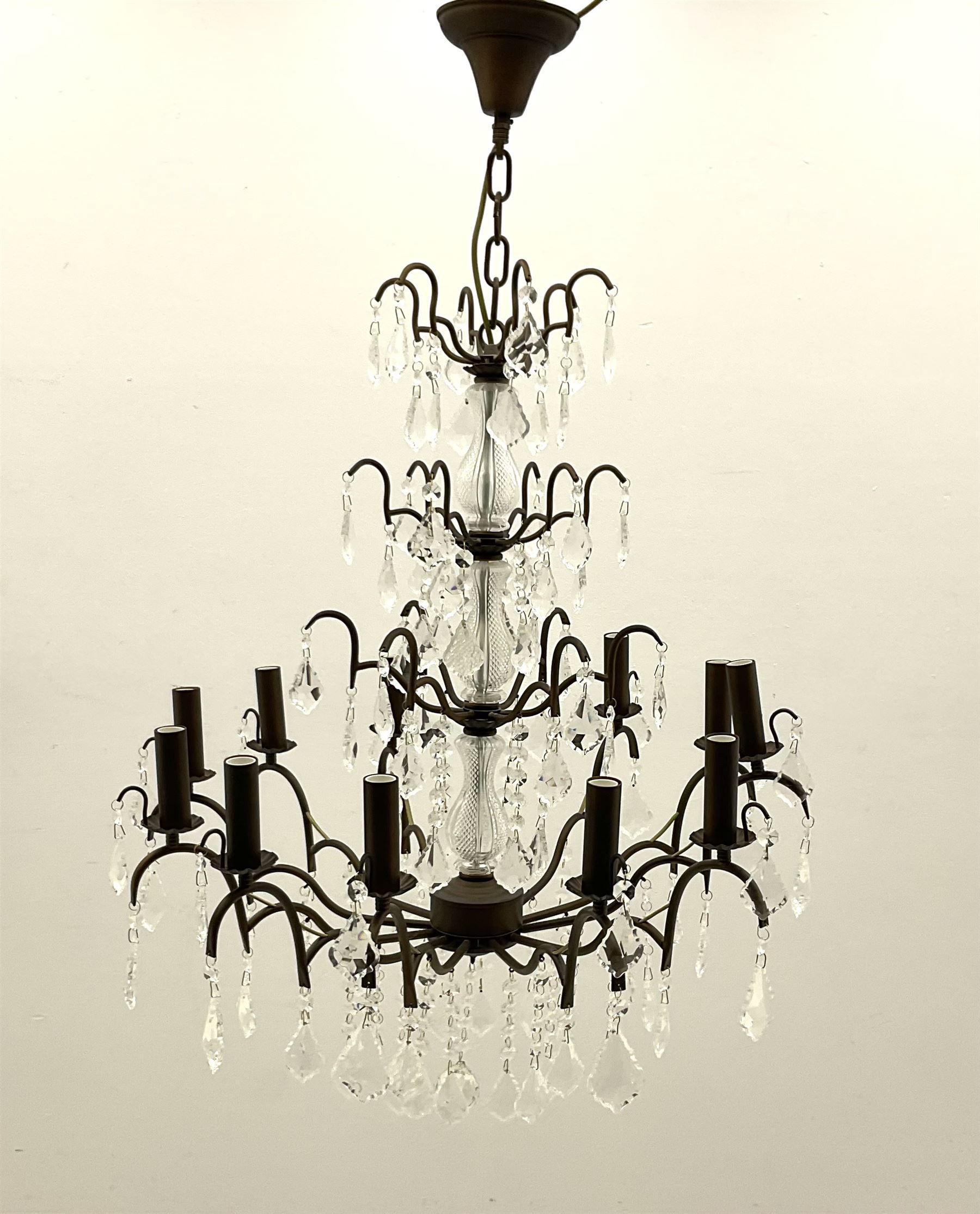 Contemporary bronze finish twelve branch chandelier, decorated with glass droplets 