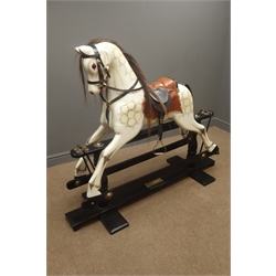  Victorian style wooden rocking horse with white painted and dappled carved sectional body, horsehair mane and tail, padded leather saddle and bridle with brass stirrups and forward and backward action on ebonised refectory style base, bearing plaque 'Special Millenium Limited Edition to mark year 2000 Serial No. 463/500', L150cm H126cm  