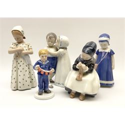 A group of figures, comprising two Royal Copenhagen examples, Armager girl knitting, model no 1314, 2011 annual figure, and three Bing & Grondahl examples, Love refused 1614, girl holding a doll 1721, and girl in blue dress 1574. (5). 