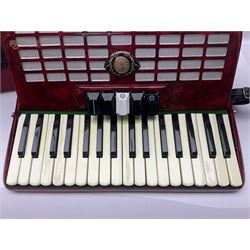 Hsinghai Studio piano accordion with red pearline finish, twenty keys and seventy-two buttons W44cm; in hard carrying case with additional The Music Room soft gig case