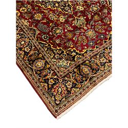 Persian Kashan deep red ground rug, all over floral design decorated with stylised flower heads, repeating guarded border
