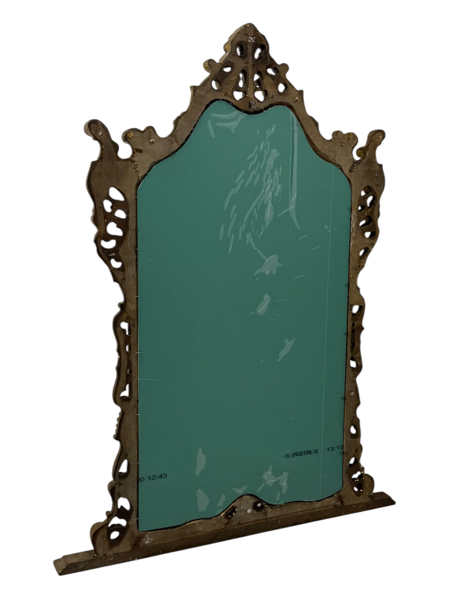 Victorian design gilt framed overmantel mirror, the arched and moulded frame adorned with scrolling foliate motifs and acanthus leaves, surmounted by a pierced cartouche, plain mirror plate, resting on a shaped base