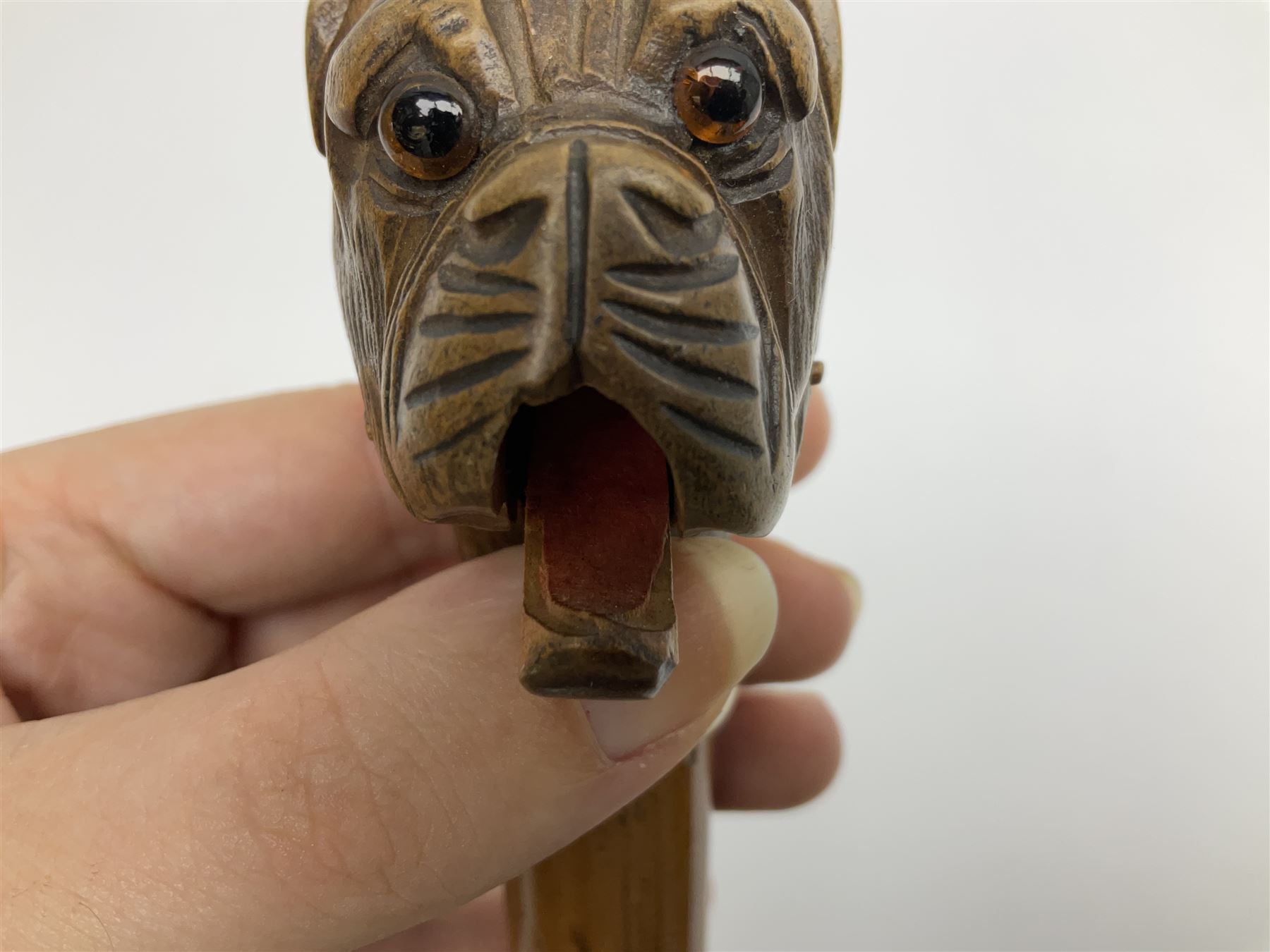 20th century walking cane, the carved wooden handle modelled as the head of a boxer dog with inset glass eyes and articulated and sprung jaw, upon a tapering Malacca shaft, L86.5cm