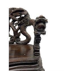Japanese Meiji period open armchair, the back carved and pierced with dragon and scrolling scaled tails, projecting dragon carved arm terminals on scrolled supports, serpentine seat with decorative band, the apron and supports with scroll and chip-carved decoration
