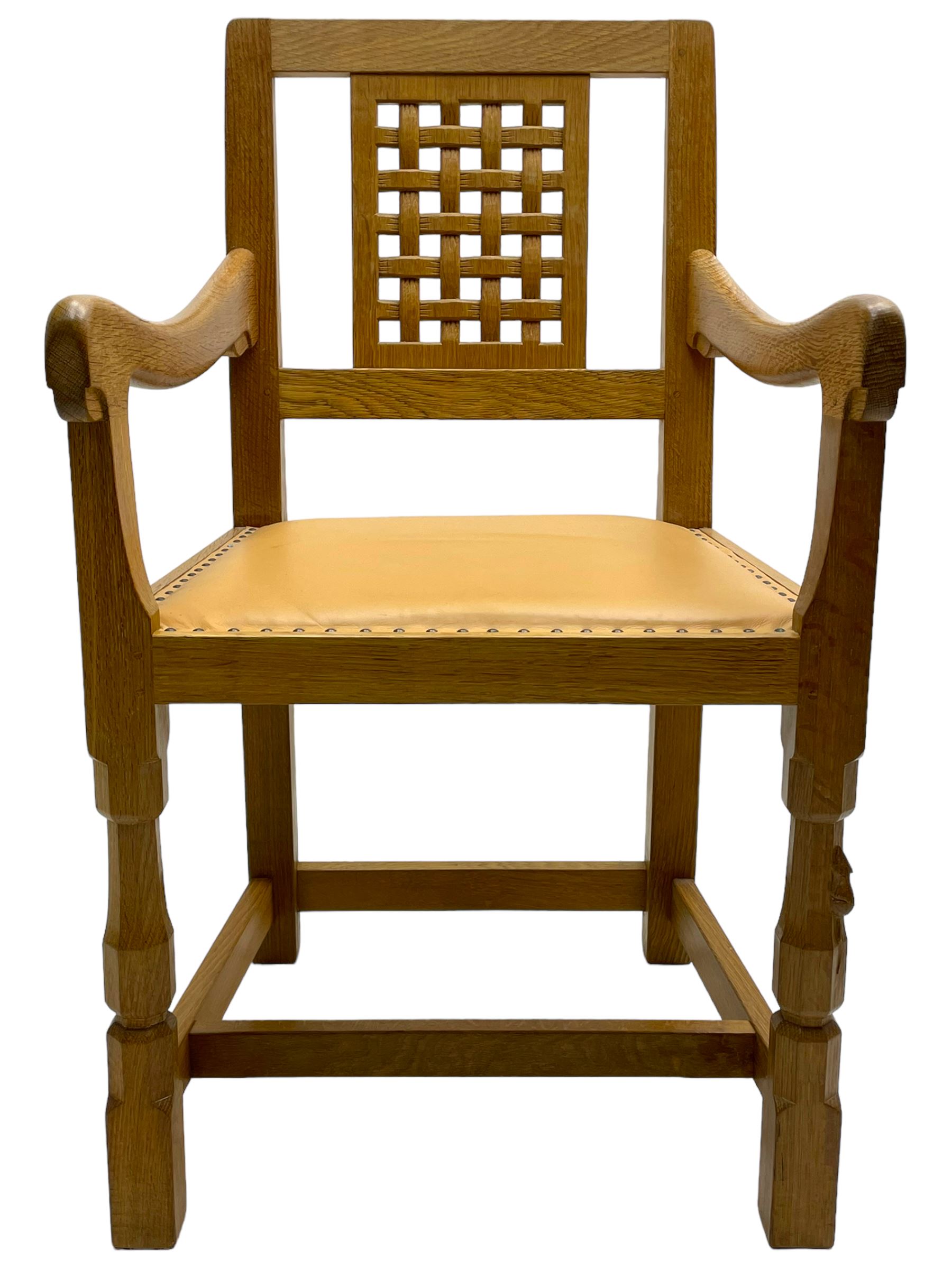 Mouseman - oak carver elbow chair, pierced and carved lattice back over leather upholstered seat with stud band, on octagonal supports united by plain stretchers, carved with mouse signature, by the workshop of Robert Thompson, Kilburn 
