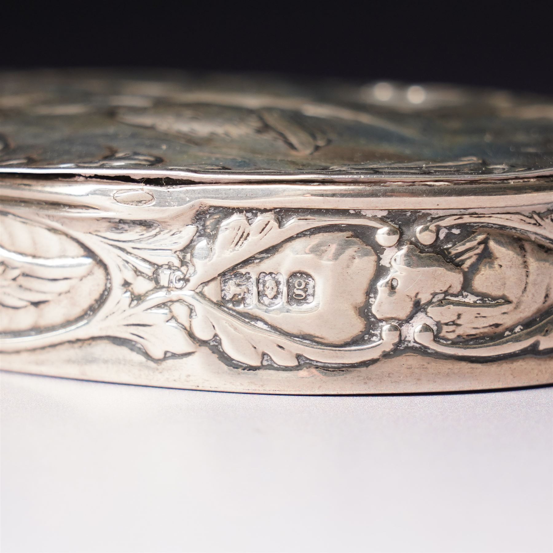 Edwardian silver oval dressing table box, the hinged cover embossed with angel heads W10cm London 1902 Maker William Comyns & Sons and an Edwardisn pierced silver oval sweetmeat basket L18cm Sheffield 1907 Maker James Dixon & Sons Ltd