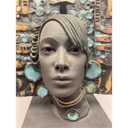 Composite bust, modelled as a woman wearing a headpiece of abstract design, decorated with applied and impressed numbers, letters and shapes, upon a black column plinth, H72cm