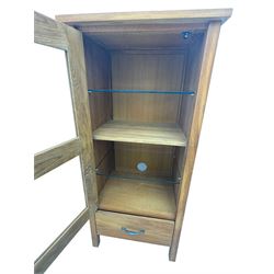 Laura Ashley - contemporary Milton oak display cabinet, featuring single door with two glass panels and pewter effect handle, enclosing one fixed oak shelf and two adjustable glass shelves, access hole at the bottom shelf, over single drawer with matching handle, on square legs