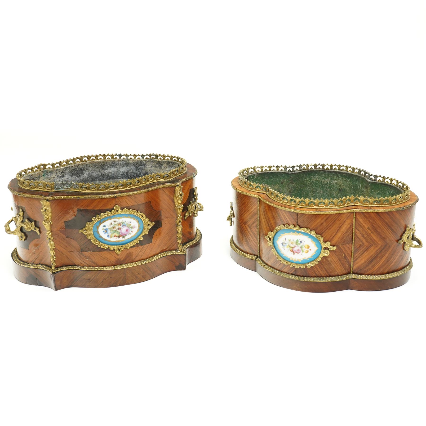 Matched pair of 19th-century French Kingwood and gilt brass mounted table jardinières, quatrefoil-shaped form with original zinc liners, foliate gilt brass mounted pierced gallery above kingwood crossbanded sides and inset serves style porcelain plaque and gilt brass carrying handles on plinth base