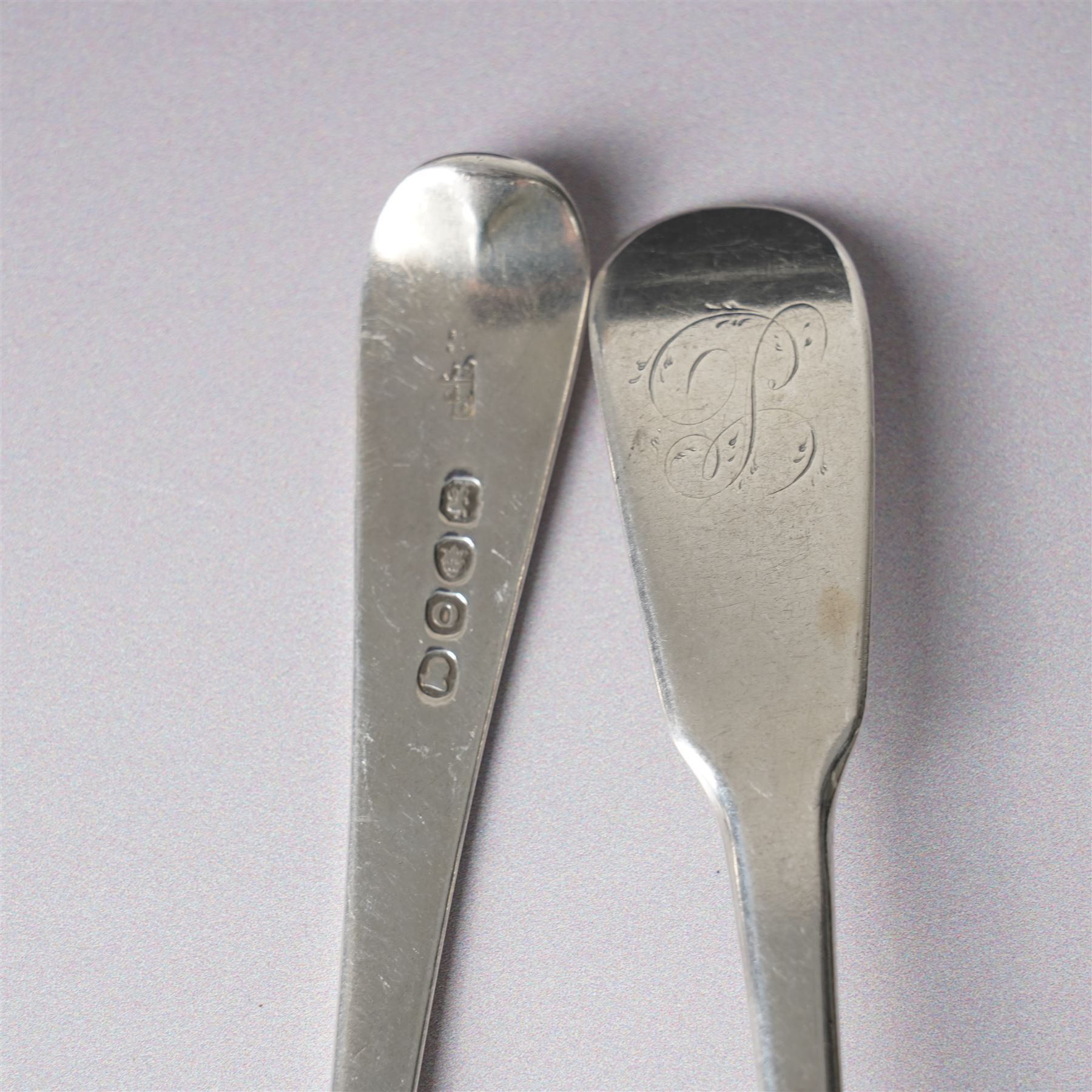 George III silver basting spoon London 1772, another engraved with initials London 1802 Thomas Wallis II, pair of table spoons London 1791 Maker Peter and Ann Bateman and two dessert spoons