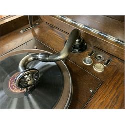 Early 20th century ‘HMV' 202 cabinet gramophone, oak cased, moulded top with foliate carved moulding hinges to reveal gramophone, two doors enclosing horn, on turned supports joined by moulded stretcher rails