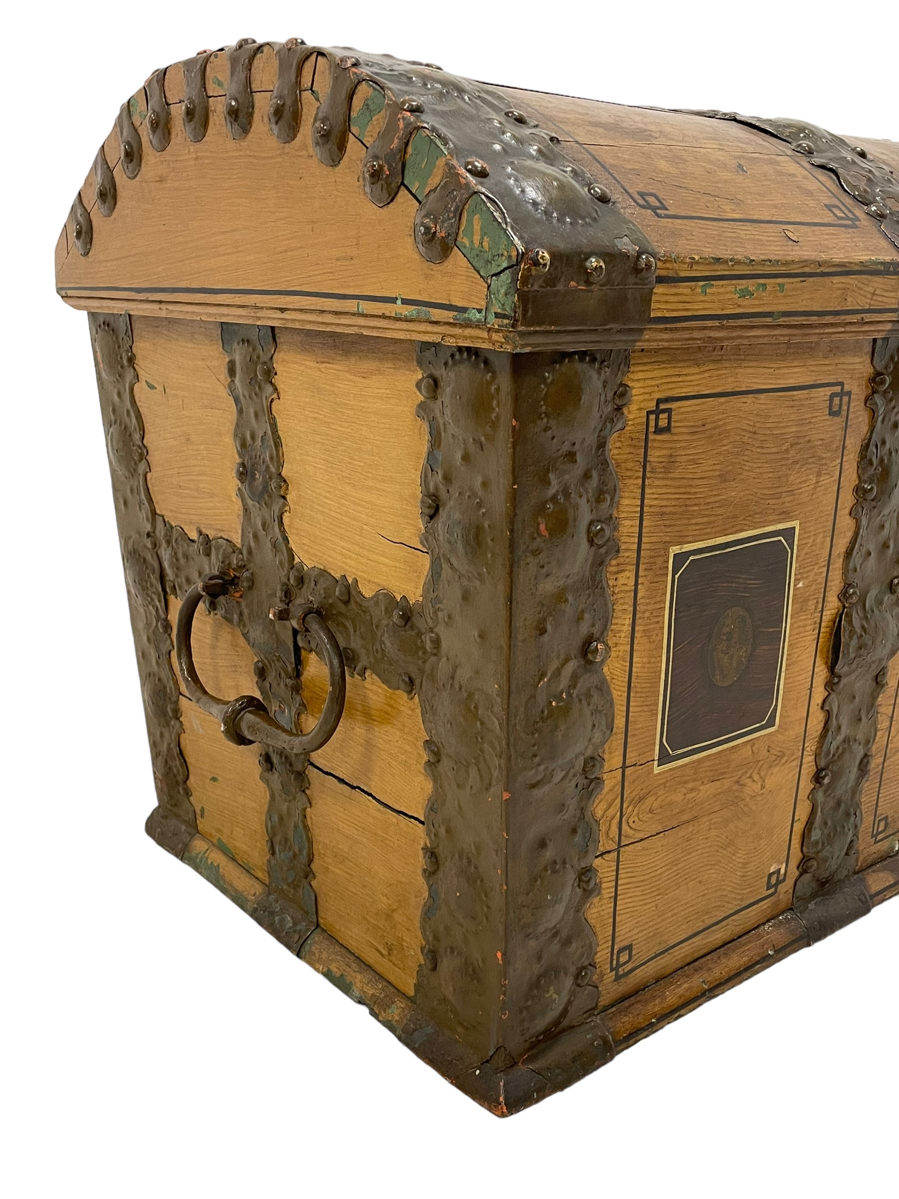 19th century painted oak sea chest, hinged dome top enclosing small compartment, bound by shaped and pressed metal strapwork, scumbled finish to resemble oak and painted with small vignettes depicting portraits and landscapes within panels, fitted with large wrought metal carrying handles, the front inscribed 'H.J.S. 1870' 