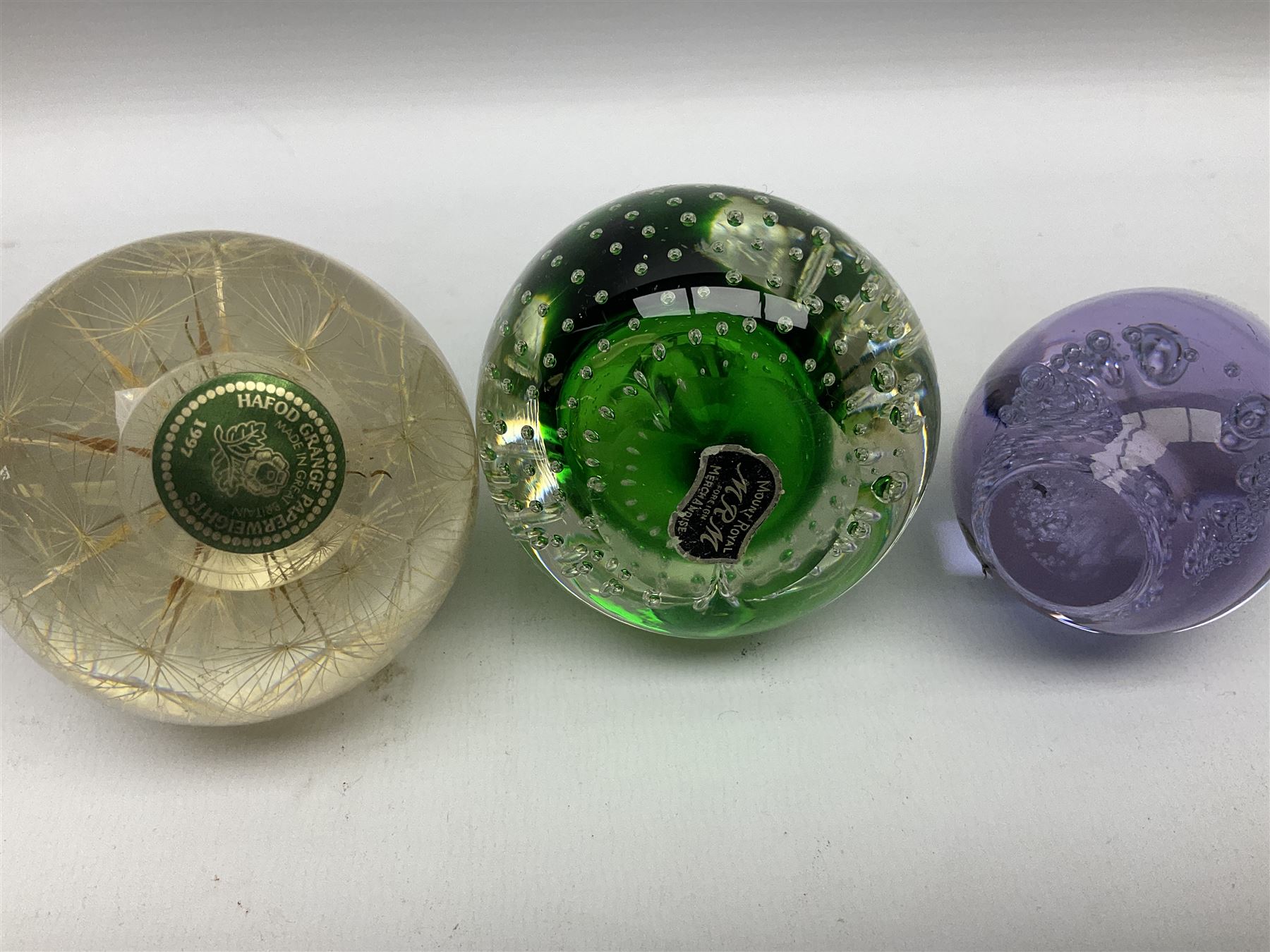 Victorian green glass dump paperweight with internal foil flower