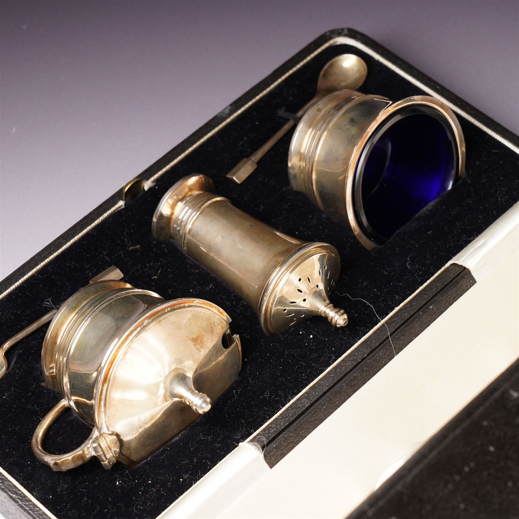 Silver three piece condiment set of circular design and two original spoons, cased Birmingham 1937-1939 Maker Deakin & Francis Ltd 