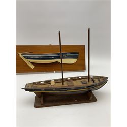 Half Block model of the Whitby Coble 'Elsinore' W.Y.7, on mahogany panel marked verso 'Bill Wedgwood R(obin) H(oods) Bay 94'L42cm; and small scratch-built model of a sailing boat L32cm on wooden stand (2)