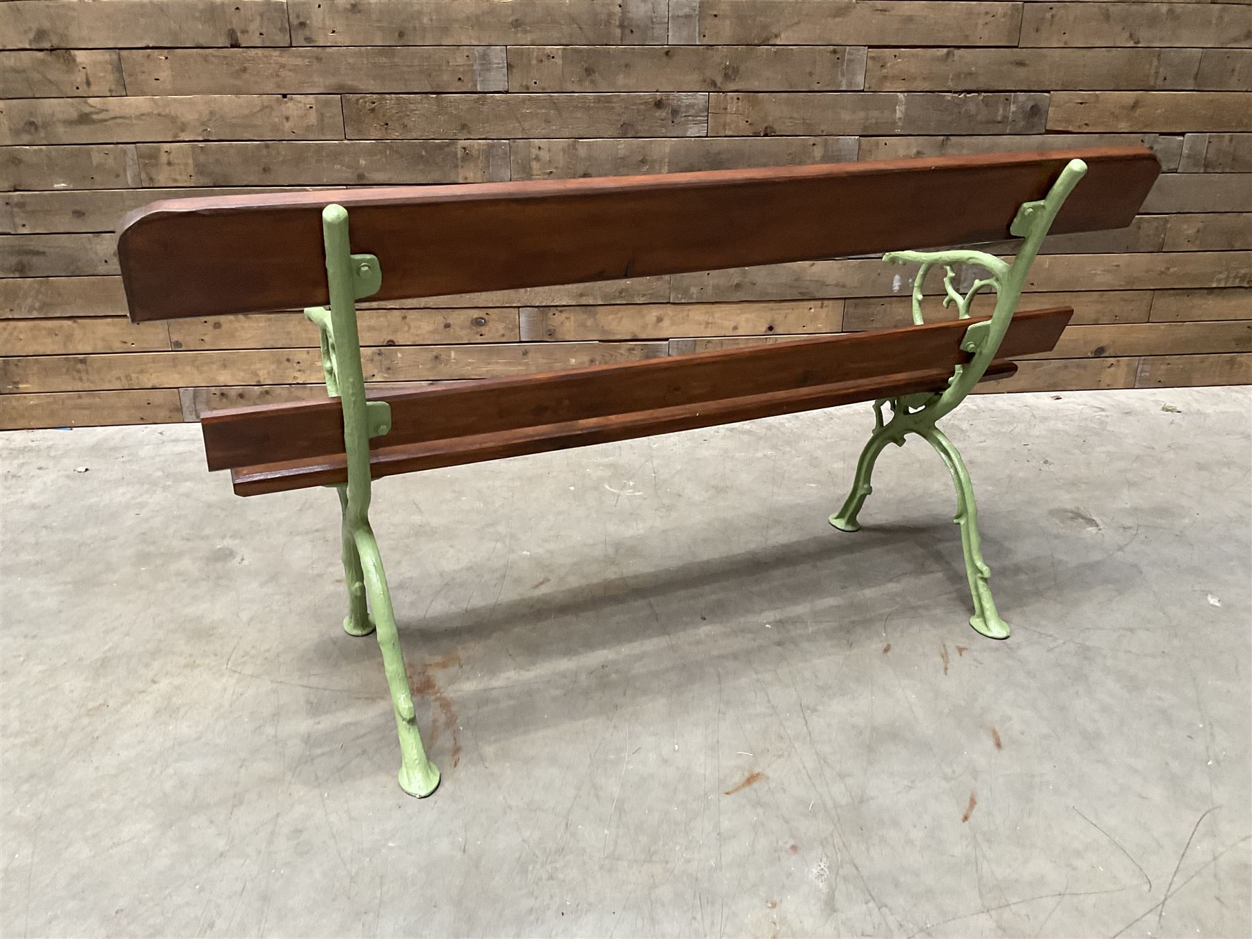 Cast iron and wood slate bench painted in green