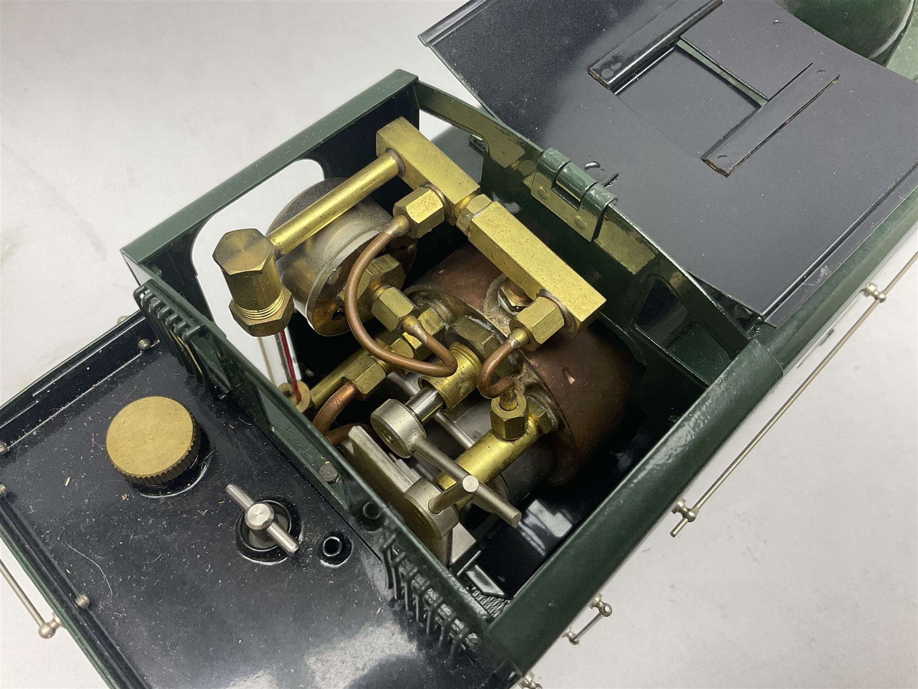 Gauge 1 - Aster 0-6-0 Great Western Railway Pannier tank locomotive No.6752; spirit fired and live steam powered with fitted steam pressure gauge, water sight glass and other usual fittings; finished in Great Western Railway green livery with GWR initials to the pannier tanks, fitted steps, handrails, checker plate, lamp irons, buffers and vacuum hoses; L31cm W8.5cm