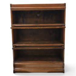 Globe Wernicke - early 20th century oak stacking bookcase, three tiers, lift up glazed doors raised on a plinth base