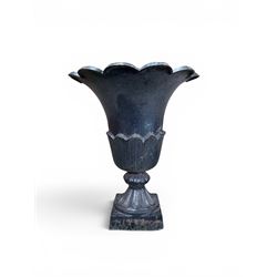 Pair of Victorian large scale cast iron garden urns, flared petal shaped rim with tapering waist, gadrooned base on square plinth, finished in black paint