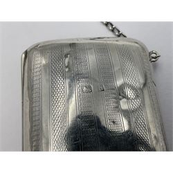 Early 20th century silver mounted coin purse, with leather interior and finger chain, hallmarked Samuel M Levi, Birmingham 1917, together with a similar Edwardian example, with engraved initials and engine turned decoration, hallmarked Birmingham 1907, maker's mark worn and indistinct, largest W11.3cm