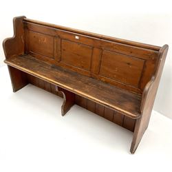 Early 20th century pine panelled back church pew, shaped solid end supports 