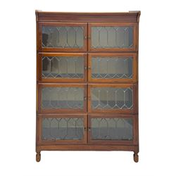 Early 20th century Globe Wernicke design stacking walnut bookcase, fitted with four sections each with two leaded glass doors, raised on turned feet