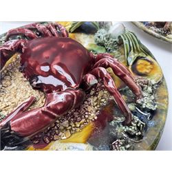 Five 20th Century Portuguese Palissy style Majolica wall plates, all depicting crustaceans to the centre modelled in relief surrounded by encrustations and shells, both with impress marks beneath, largest D29cm