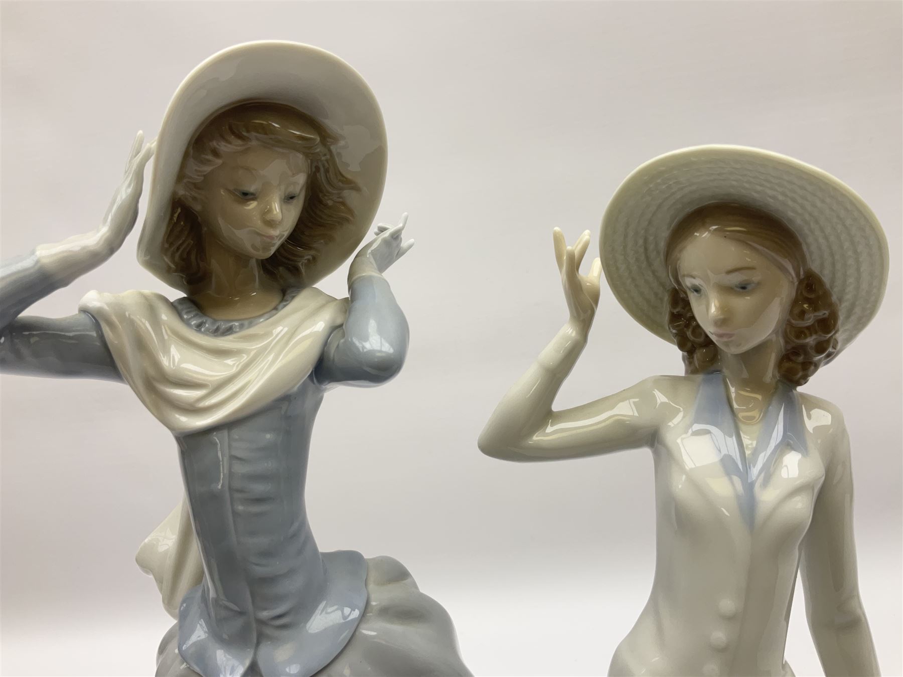 Three Lladro figures, comprising, Dreams of Summer Past no 6401, Spring Breeze no 4936 and Breezy Afternoon 5682 together with Lladro plaque Art Brings us Together no 7677, all in original boxes, largest example H35cm