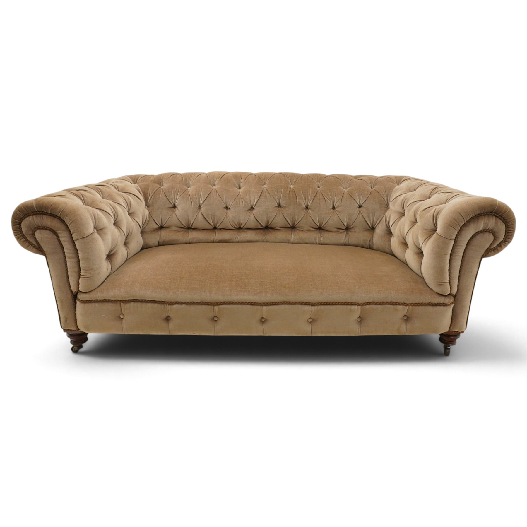 Victorian mahogany framed two seater Chesterfield settee, traditional shape with rolled back and arms over sprung seat, upholstered in buttoned-back neutral fabric, raised on turned front supports with ceramic castors