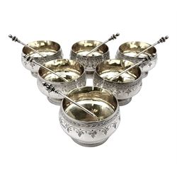 Set of six Victorian silver open salts, each of squat goblet form with gilt interior, engraved with foliate bands, upon stepped circular base, with six matching salt spoons with gilt bowls, all hallmarked Thomas White, London 1881, 1882 and 1884, contained within a hexagonal tooled leather, silk and velvet lined fitted case, salts H3.8cm