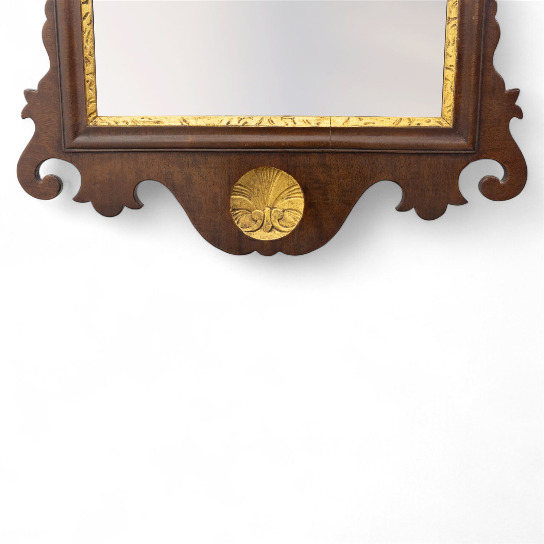 George III mahogany side table, the rectangular moulded top above a single frieze drawer fitted with brass swan neck handles, above a shaped serpentine apron raised upon square section legs, W86 D42 H75cm, together with a George III fretwork mirror, the rectangular plate within a gilt slip surmounted by a pierced crest with inset carved Ho-Ho bird, with shaped apron with gilt shell motif, H84cm W45cm