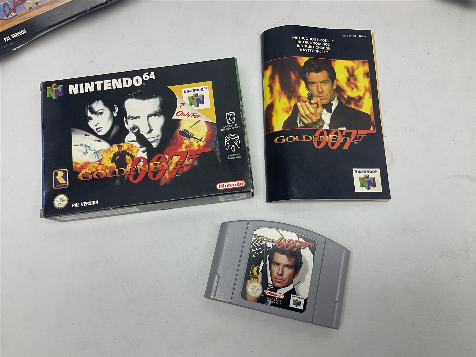 Nintendo 64 console, two controllers, games and accessories. Accessories to include the ‘Tremorpak’ and ‘Spook’ 2 Phono plugs and a S-VHS plug with adapter, both in original boxes. Games to include ‘Golden Eye 007’, ‘Doom 64’, ‘Killer Instinct Gold’, ‘Tetrisphere’, ‘F-1 World Grand Prix’, ‘Pilotwings 64’ and ‘Lylatwars’ with ‘Rumble Pak’, all with original boxes and instruction manuals. ‘Star Wars Episode I Racer’ game cartridge in Shadows of the Empire box. 