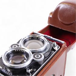 Rolleiflex Franke & Heidecke DBP DBGM 2.8 F TLR camera serial no. 2439093, with a Heidosmat 1:2.8/80 lens serial no. 894062 and a Carl Zeiss Planer 1:2.8 f=80mm lens serial no. 4092068, in leather case with instruction booklet
