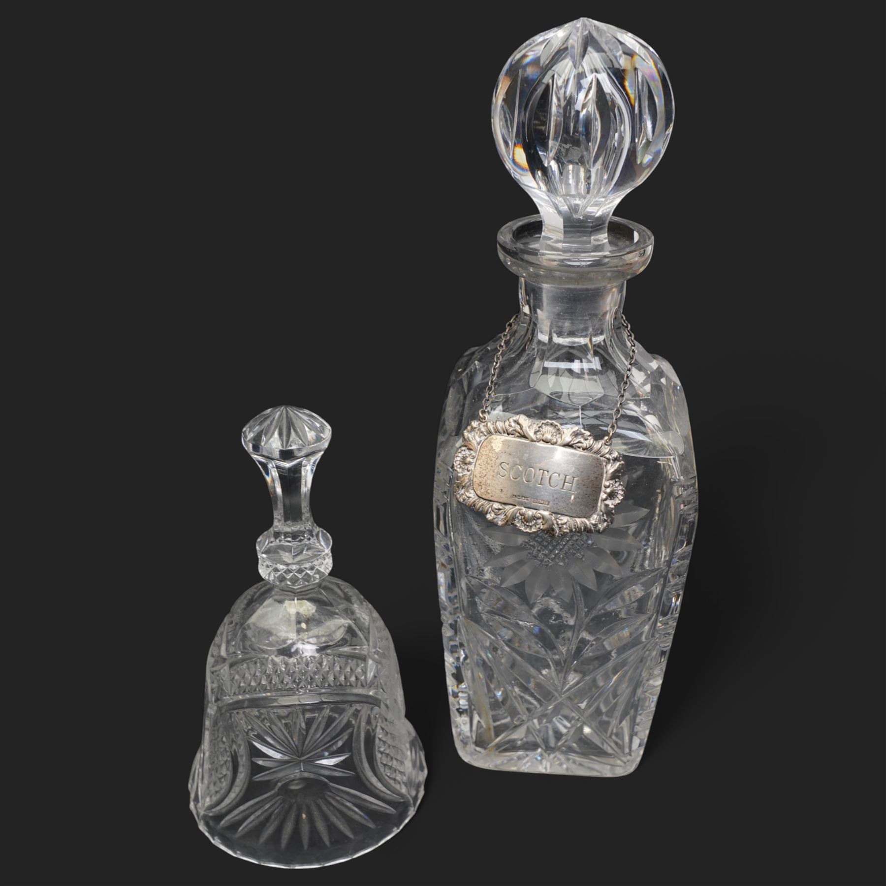 Six crystal decanters, four with silver labels and one with silver plated mount, and one etched glass dinner bell, tallest H30cm 