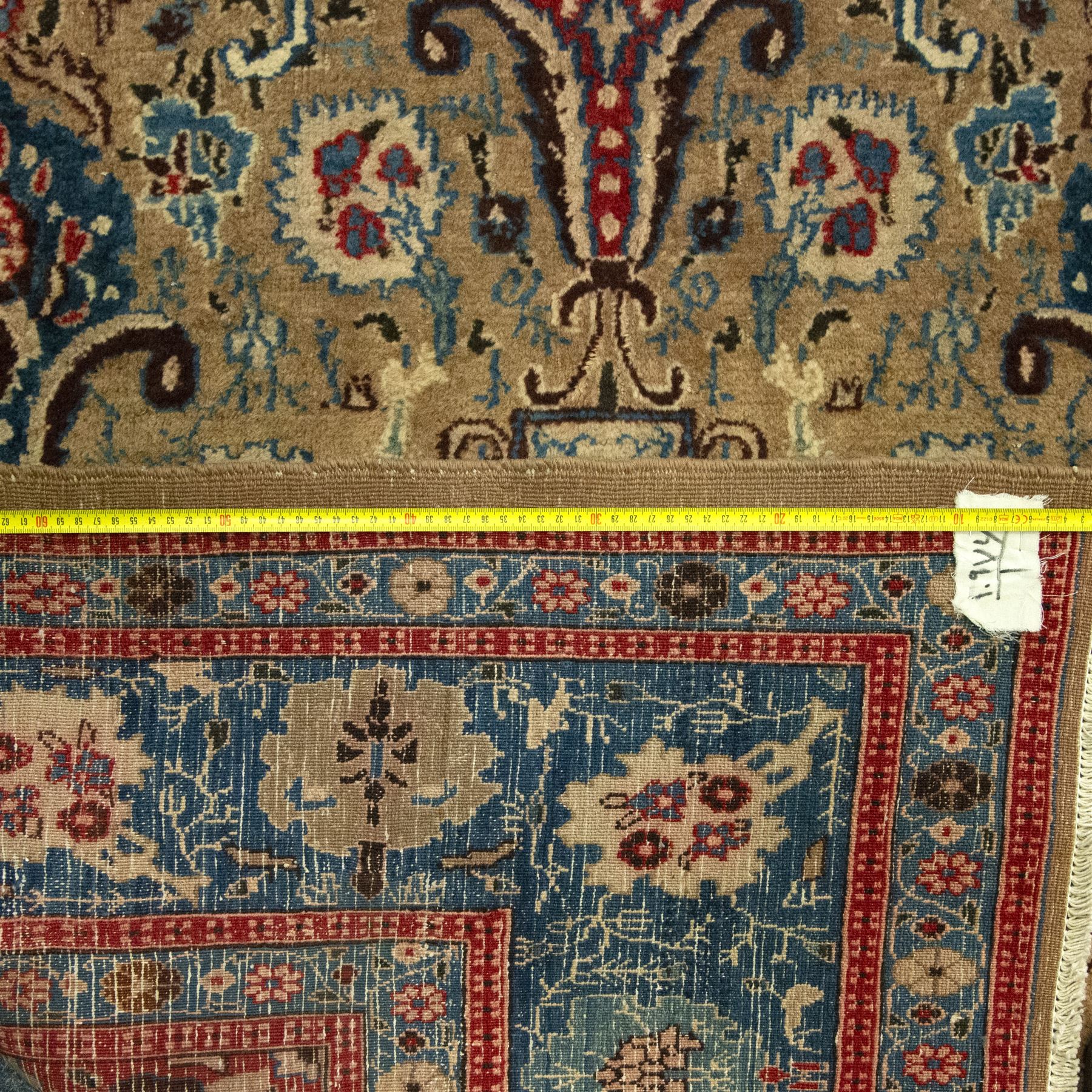 Central-Western Persian Sarouk hand-knotted carpet, beige ground, with an all-over design of boteh and floral sprays in red and blue within a floral border on blue ground 