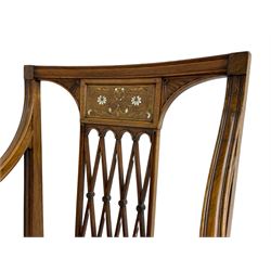 Edwardian Sheraton revival rosewood elbow chair, moulded cresting rail over frieze panel inlaid with scrolling foliate, fan carved corner brackets over an overlapping lattice splat, swept and moulded arms with scroll and acanthus carved terminals, curved supports with foliate carved capitals, the seat upholstered in leather with studwork band, square tapering supports with spade feet inlaid with boxwood stringing and trailing bell flower motifs

This item has been registered for sale under Section 10 of the APHA Ivory Act 
