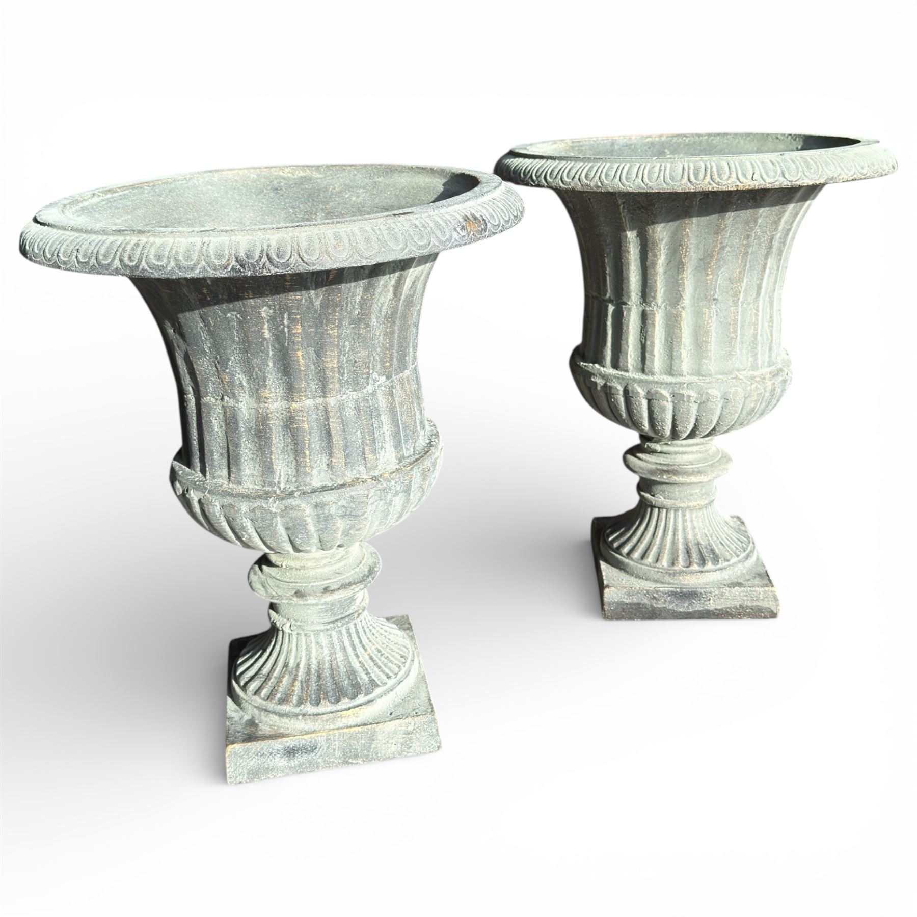 Pair of cast iron Urns on square bases