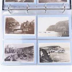 Four-hundred and twelve early 20th century Whitby District view real photographic postcards, including a selection from the Whitby Coast (176), starting at Staithes and Runswick Bay down to Robin Hoods Bay and a selection from the Valley of the River Esk (236), including Ruswarp, Rig Mill, Sneaton, Sleights, Grosmont, Egton, Glaisdale, Danby, Castleton and Goathland, all housed within two postcard albums