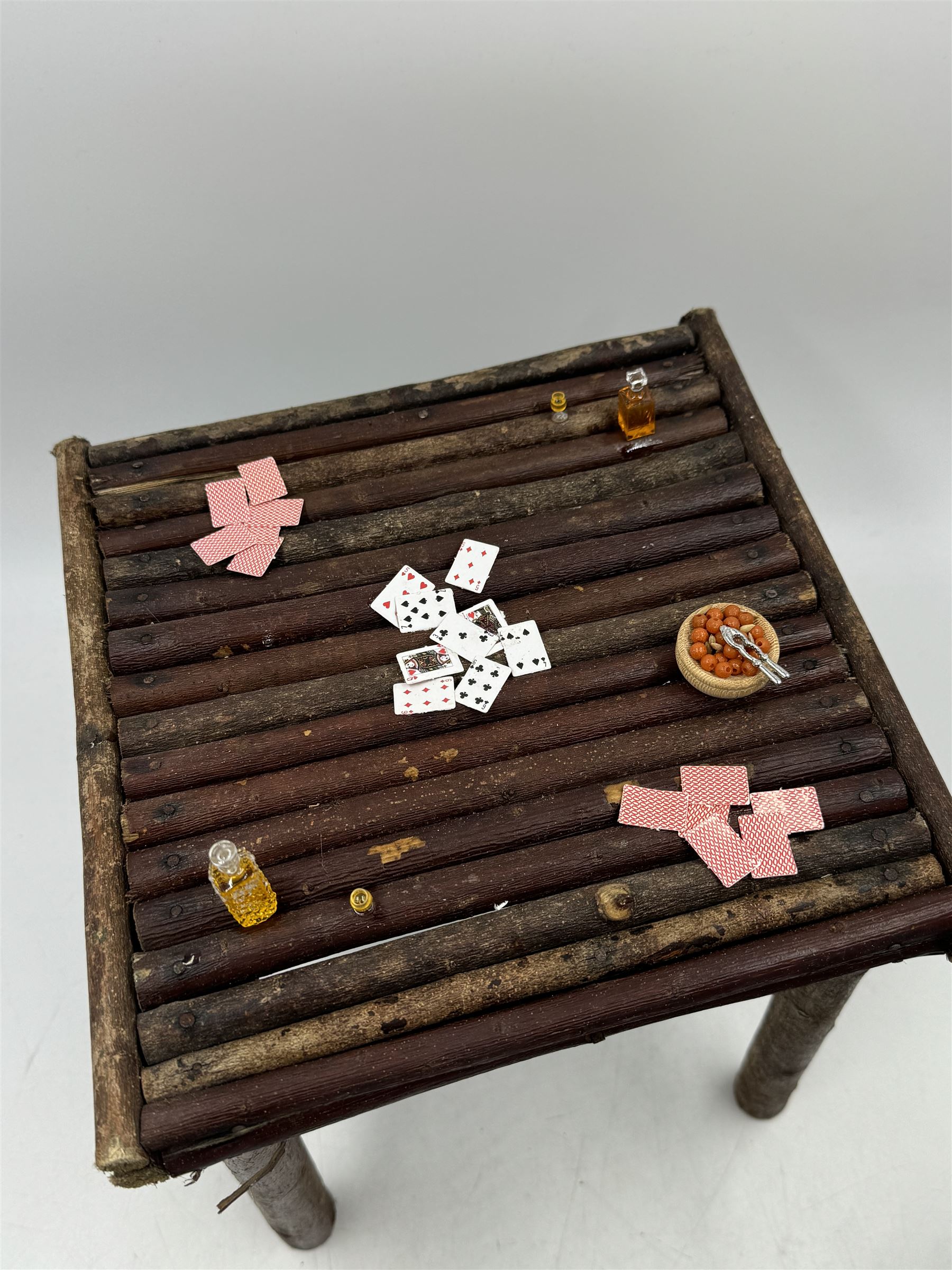 Anthropomorphic Taxidermy: Two red squirrels (Sciurus vulgaris), both seated upon a chair holding playing cards, one smoking a pipe 