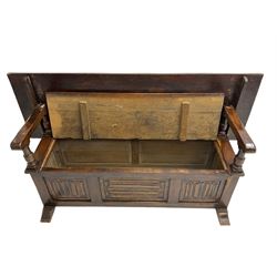 Jacobean design oak Monks bench, the front with carved linenfold panels, hinged metaphoric table back, hinged box seat compartment, on sledge feet