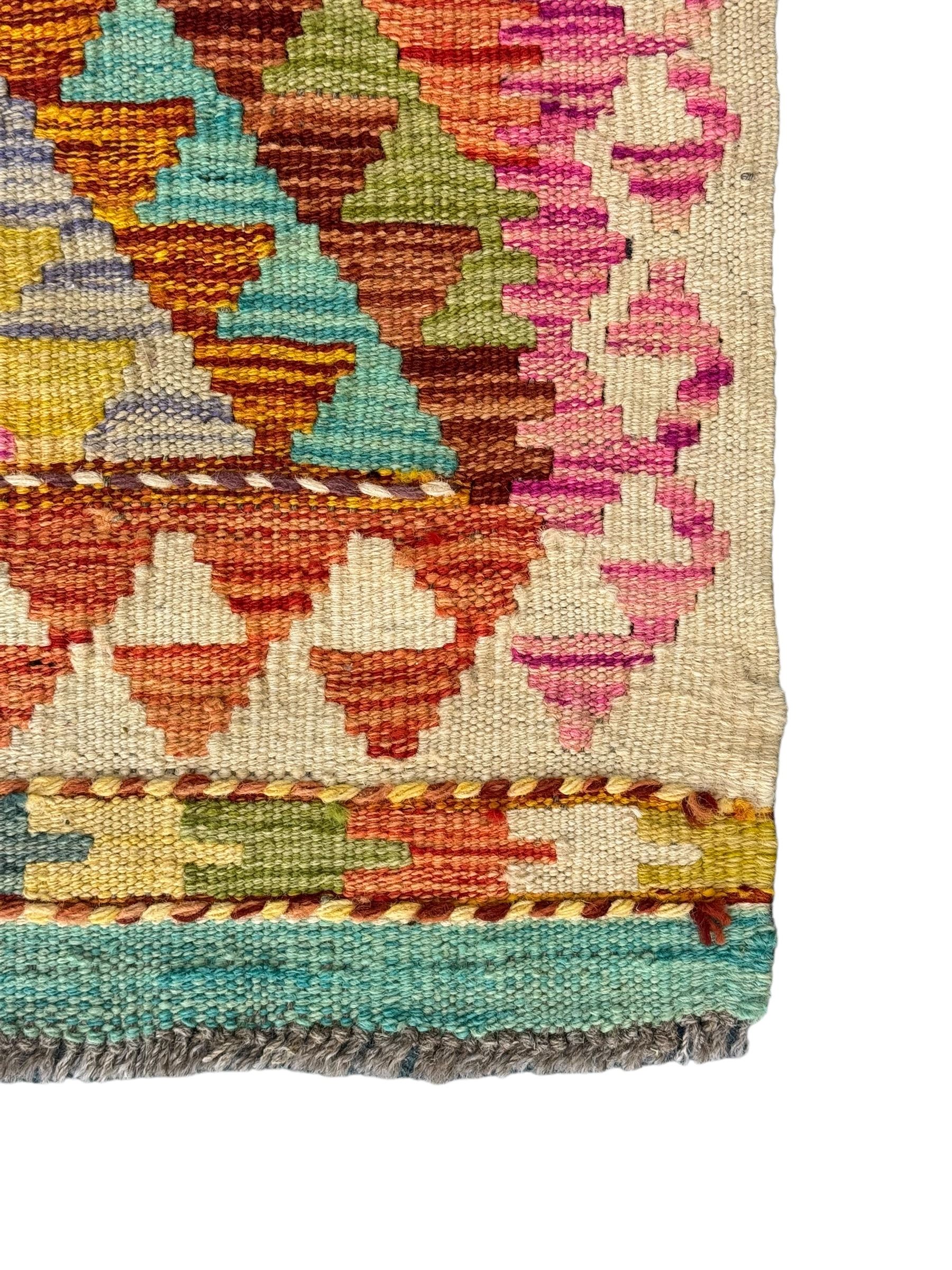 Tibetan-design handwoven rug, deep red field with three central medallions in yellow and blue, traditional yellow key border, white fringes on both ends