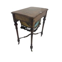 Victorian figured walnut work table, hinged rectangular top inlaid with scrolling foliate decoration, the fitted interior with satinwood fretwork lids, over the upholstered basket well with fringing, raised on turned and fluted supports united by shaped X-stretcher, on ceramic castors